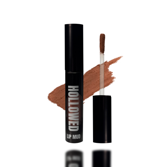 LIP MUD IN BLACK PACKAGING WITH A WINDOW TO SEE COLOR AND NEXT TO THE PRODUCT'S WAND. COLOR SWATCH BEHIND PRODUCT OF A MEDIUM BROWN RUST COLOR