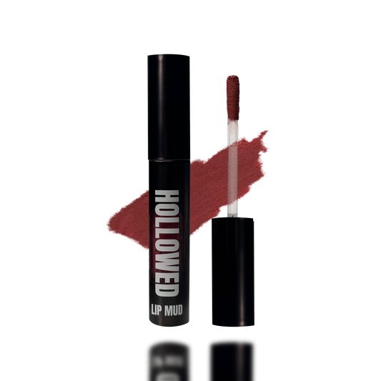 LIP MUD IN BLACK PACKAGING WITH A WINDOW TO SEE COLOR AND NEXT TO THE PRODUCT'S WAND. COLOR SWATCH BEHIND PRODUCT OF A MEDIUM ROSE PINK COLOR